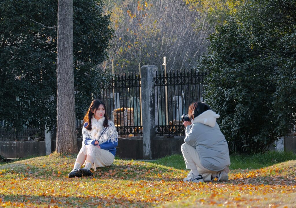 a couple of people that are sitting in the grass