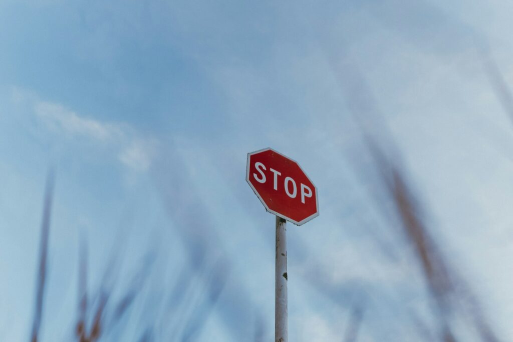 A red stop sign sitting on top of a metal pole